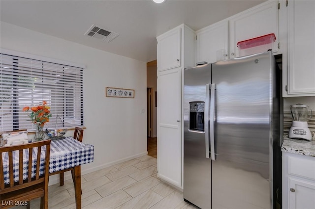 368 Umbria Way, Henderson, NV 89014 - kitchen with stainless steel fridge with ice dispenser, white cabinetry, light stone counters, and light tile patterned floors