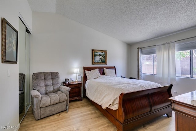 368 Umbria Way, Henderson, NV 89014 - bedroom featuring vaulted ceiling, light wood finished floors, and a textured ceiling