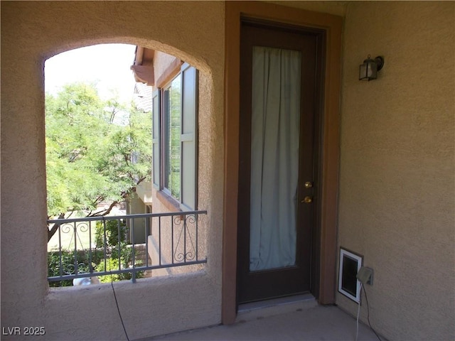 11832 Arenoso Dr, Las Vegas, NV 89138 - view of exterior entry featuring stucco siding and a balcony
