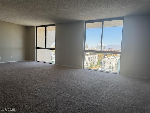 3930 University Center Dr Unit 901, Las Vegas, NV 89119 - carpeted empty room featuring floor to ceiling windows, a textured ceiling, and a city view
