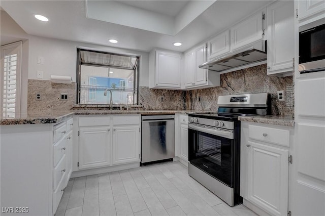 1516 Frandosa Ln, Las Vegas, NV 89117 - kitchen with appliances with stainless steel finishes, under cabinet range hood, white cabinets, light stone countertops, and backsplash
