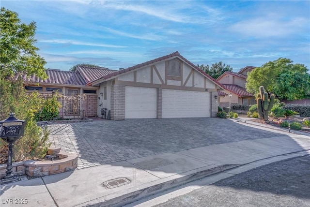 1516 Frandosa Ln, Las Vegas, NV 89117 - view of front facade with a garage, stucco siding, decorative driveway, and a tiled roof