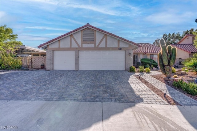 1516 Frandosa Ln, Las Vegas, NV 89117 - view of front facade featuring decorative driveway, an attached garage, stucco siding, brick siding, and a tiled roof