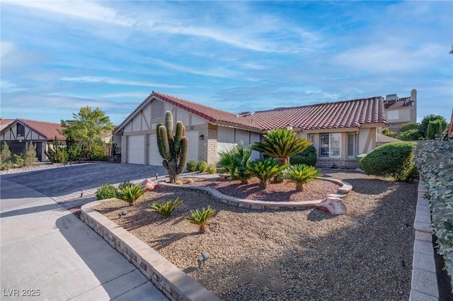 1516 Frandosa Ln, Las Vegas, NV 89117 - view of front of home with a tiled roof, an attached garage, decorative driveway, stucco siding, and brick siding
