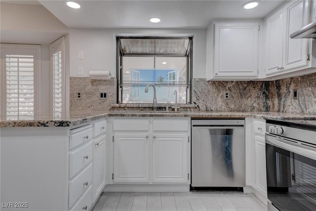 1516 Frandosa Ln, Las Vegas, NV 89117 - kitchen featuring stainless steel appliances, white cabinets, light stone counters, healthy amount of natural light, and recessed lighting