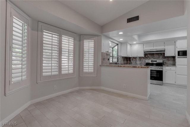 1516 Frandosa Ln, Las Vegas, NV 89117 - kitchen featuring electric range, built in microwave, under cabinet range hood, decorative backsplash, and vaulted ceiling