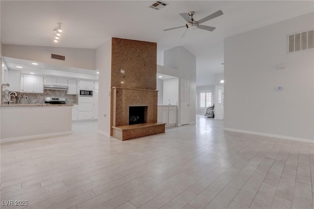 1516 Frandosa Ln, Las Vegas, NV 89117 - unfurnished living room with ceiling fan, a premium fireplace, light wood finished floors, and high vaulted ceiling