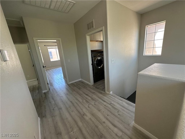 7537 Brisa Del Mar Ave, Las Vegas, NV 89179 - corridor featuring washer / dryer, light wood-style flooring, and an upstairs landing
