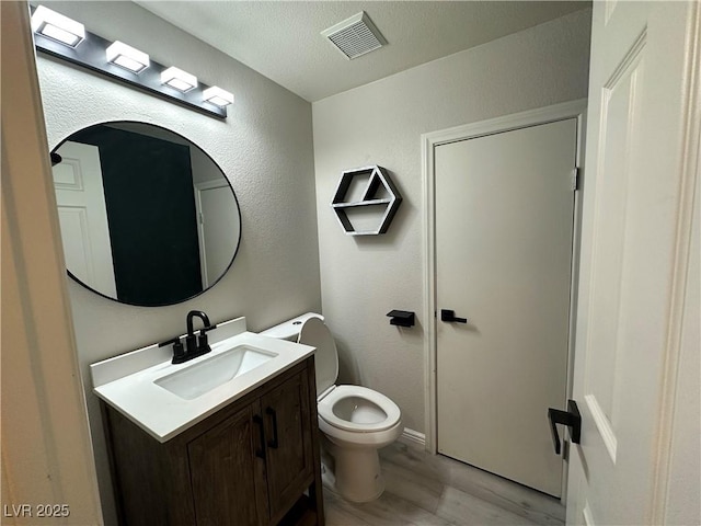7537 Brisa Del Mar Ave, Las Vegas, NV 89179 - half bathroom with vanity, wood finished floors, and a textured wall