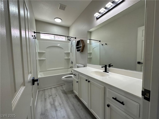7537 Brisa Del Mar Ave, Las Vegas, NV 89179 - bathroom featuring vanity, wood finished floors, shower / washtub combination, and a textured ceiling