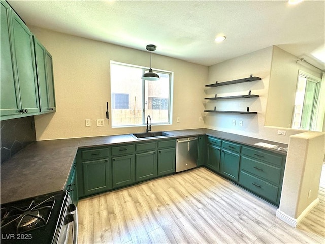 7537 Brisa Del Mar Ave, Las Vegas, NV 89179 - kitchen with green cabinetry, dishwasher, black range with gas cooktop, light wood-type flooring, and recessed lighting