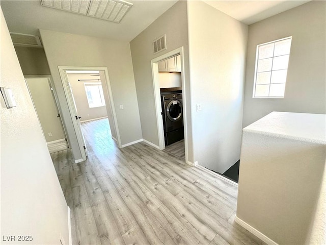 7537 Brisa Del Mar Ave, Las Vegas, NV 89179 - hallway with washer / dryer and light wood finished floors