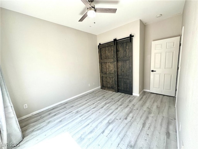 7537 Brisa Del Mar Ave, Las Vegas, NV 89179 - unfurnished bedroom with wood finished floors, a barn door, and a ceiling fan