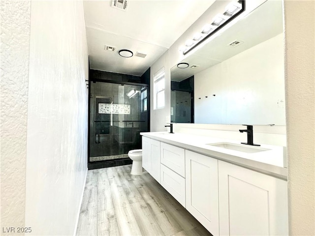 7537 Brisa Del Mar Ave, Las Vegas, NV 89179 - bathroom featuring a shower stall, double vanity, and wood finished floors