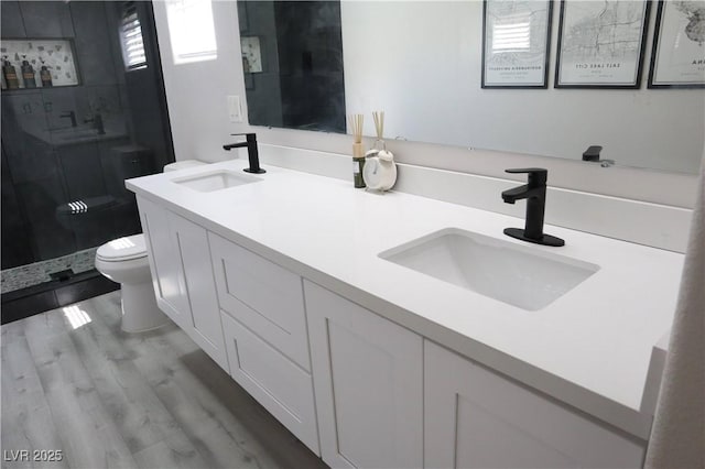 7537 Brisa Del Mar Ave, Las Vegas, NV 89179 - bathroom featuring a shower stall, double vanity, and wood finished floors