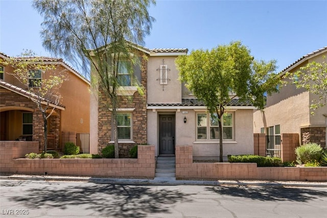 11063 Mount George St, Las Vegas, NV 89179 - mediterranean / spanish home featuring stucco siding, a tiled roof, and stone siding