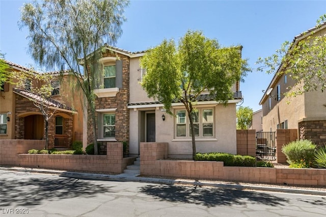 11063 Mount George St, Las Vegas, NV 89179 - view of front of house featuring stucco siding, stone siding, a tiled roof, and a gate