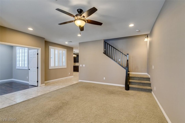 11063 Mount George St, Las Vegas, NV 89179 - unfurnished living room with a ceiling fan, carpet floors, stairway, recessed lighting, and tile patterned floors