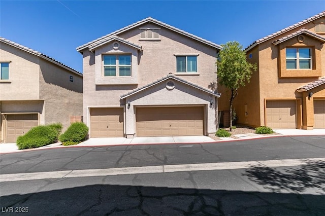 11063 Mount George St, Las Vegas, NV 89179 - view of front of property with an attached garage, stucco siding, and a tile roof