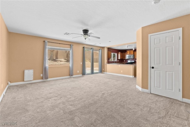 9175 Titan Hill Ct, Las Vegas, NV 89148 - unfurnished living room with ceiling fan, light colored carpet, and healthy amount of natural light