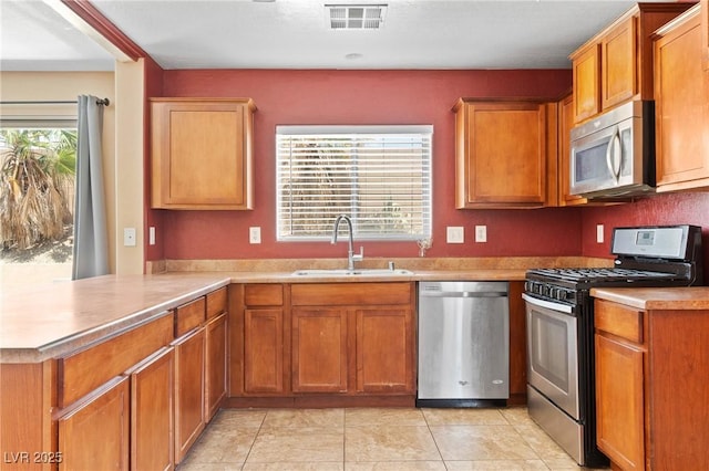 9175 Titan Hill Ct, Las Vegas, NV 89148 - kitchen with appliances with stainless steel finishes, light countertops, light tile patterned flooring, and brown cabinetry
