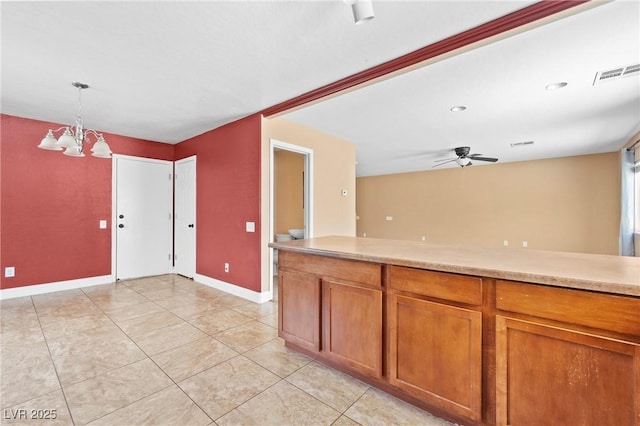 9175 Titan Hill Ct, Las Vegas, NV 89148 - kitchen featuring a chandelier, light countertops, brown cabinets, and ceiling fan