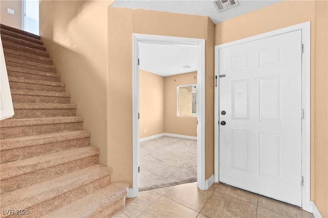 9175 Titan Hill Ct, Las Vegas, NV 89148 - foyer with stairs, light tile patterned flooring, and light carpet
