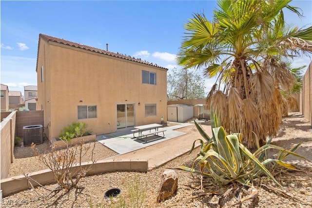 9175 Titan Hill Ct, Las Vegas, NV 89148 - back of house with a patio, stucco siding, a storage shed, and a fenced backyard