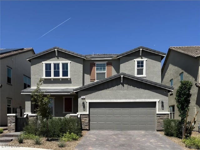 2645 Cava Tirreni St, Henderson, NV 89044 - craftsman house with stone siding, driveway, an attached garage, and stucco siding