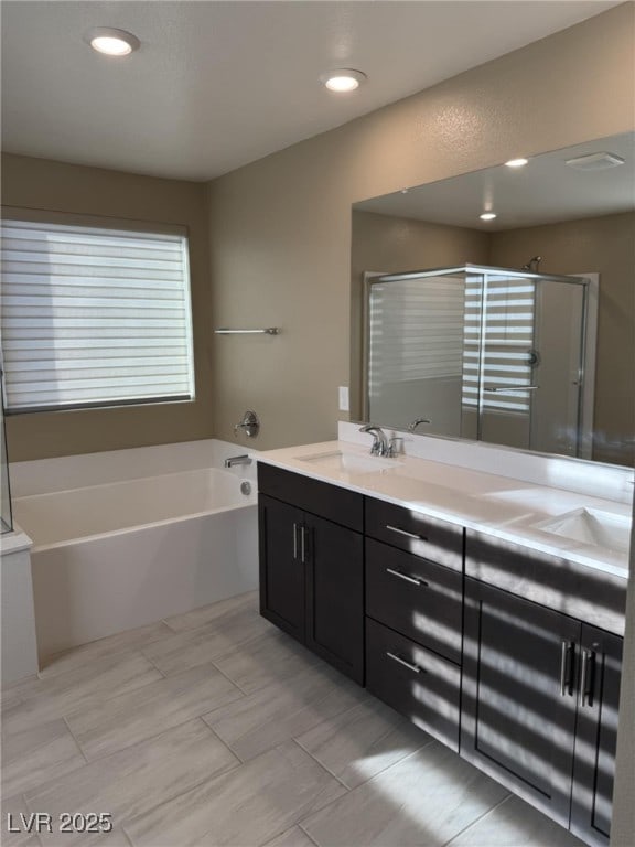 2645 Cava Tirreni St, Henderson, NV 89044 - bathroom featuring double vanity, a bath, and a shower stall