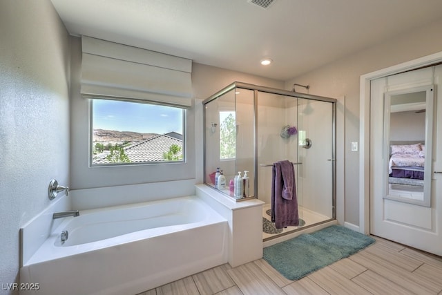 9785 W Meranto Ave, Las Vegas, NV 89178 - bathroom with a garden tub, a shower stall, healthy amount of natural light, recessed lighting, and wood finish floors