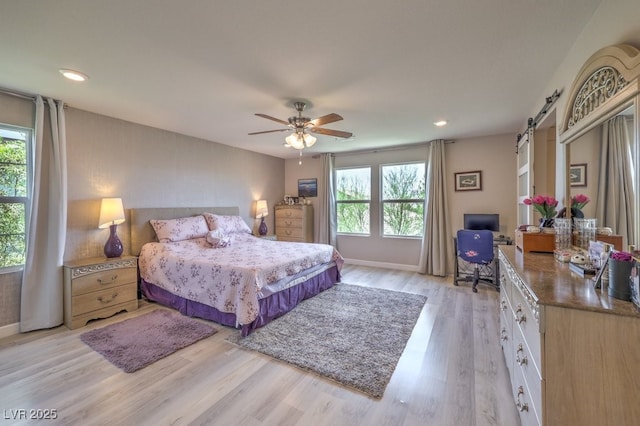 9785 W Meranto Ave, Las Vegas, NV 89178 - bedroom featuring a barn door, multiple windows, light wood-style floors, recessed lighting, and an office area