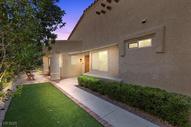 7627 Boca Raton Dr, Las Vegas, NV 89113 - property entrance featuring stucco siding and a lawn