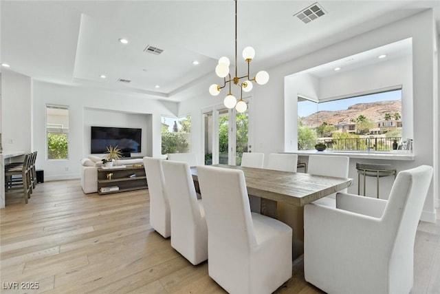 2797 Turtle Head Peak Dr, Las Vegas, NV 89135 - dining area featuring light wood-style flooring, a raised ceiling, recessed lighting, and a chandelier