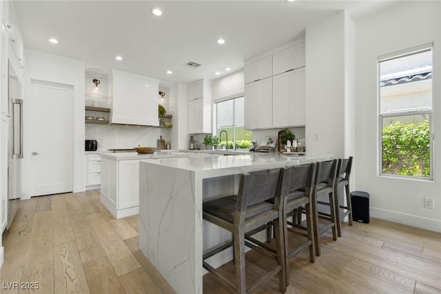 2797 Turtle Head Peak Dr, Las Vegas, NV 89135 - kitchen featuring a peninsula, light wood-type flooring, open shelves, a breakfast bar area, and recessed lighting