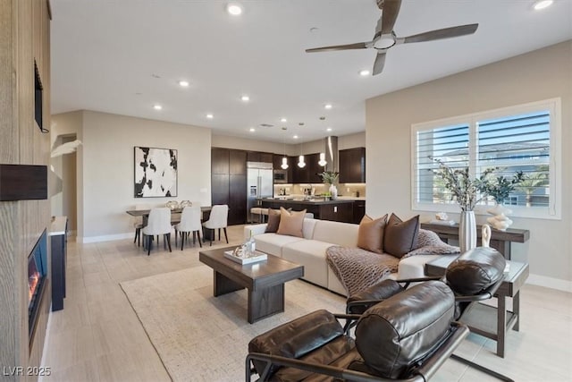 120 Los Cabos Dr Unit 301, Las Vegas, NV 89144 - living room with recessed lighting, ceiling fan, a glass covered fireplace, and light wood finished floors