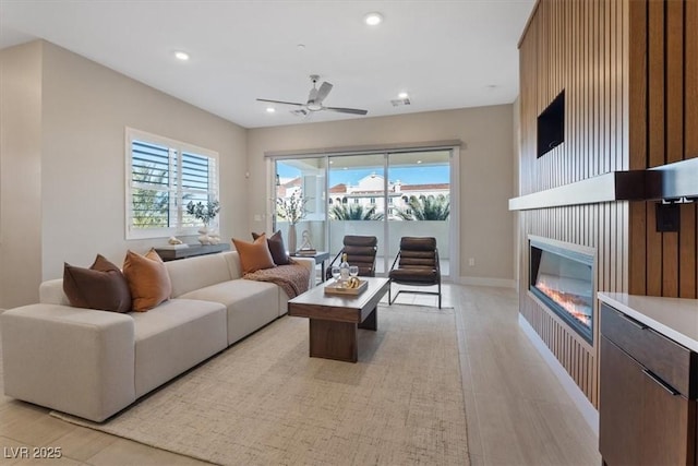 120 Los Cabos Dr Unit 301, Las Vegas, NV 89144 - living area with light wood finished floors, plenty of natural light, a ceiling fan, a glass covered fireplace, and recessed lighting