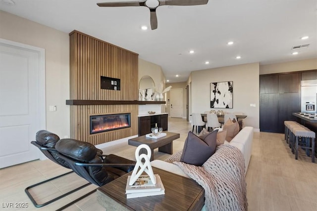 120 Los Cabos Dr Unit 301, Las Vegas, NV 89144 - living area featuring a glass covered fireplace, ceiling fan, and recessed lighting