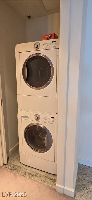 4471 Dean Martin Dr Unit 1104, Las Vegas, NV 89103 - laundry room with stacked washing machine and dryer and baseboards
