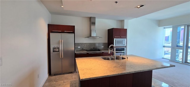 4471 Dean Martin Dr Unit 1104, Las Vegas, NV 89103 - kitchen with stainless steel appliances, wall chimney exhaust hood, modern cabinets, dark brown cabinetry, and a center island with sink