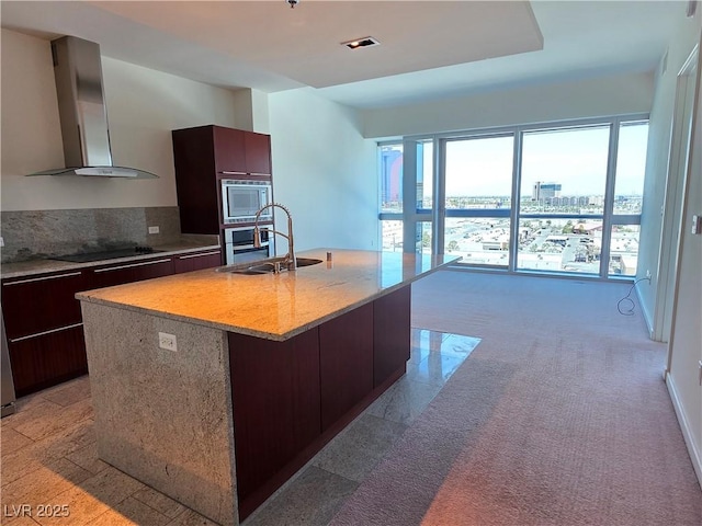 4471 Dean Martin Dr Unit 1104, Las Vegas, NV 89103 - kitchen featuring range hood, stainless steel microwave, modern cabinets, an island with sink, and black electric cooktop