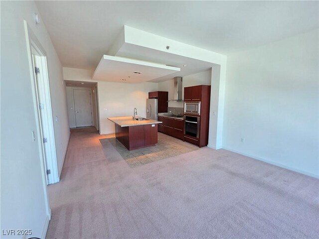 4471 Dean Martin Dr Unit 1104, Las Vegas, NV 89103 - kitchen featuring stainless steel appliances, wall chimney exhaust hood, light carpet, an island with sink, and light countertops