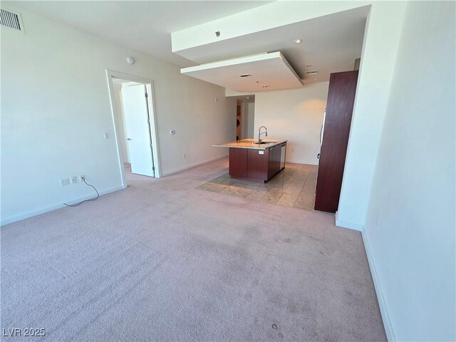 4471 Dean Martin Dr Unit 1104, Las Vegas, NV 89103 - unfurnished living room featuring light carpet and a sink