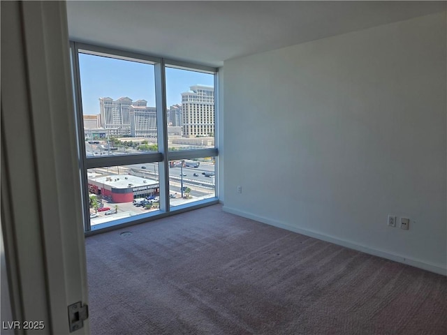 4471 Dean Martin Dr Unit 1104, Las Vegas, NV 89103 - carpeted empty room with a city view and floor to ceiling windows