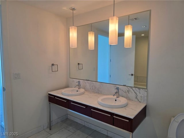 4471 Dean Martin Dr Unit 1104, Las Vegas, NV 89103 - full bathroom featuring double vanity and marble look tiles