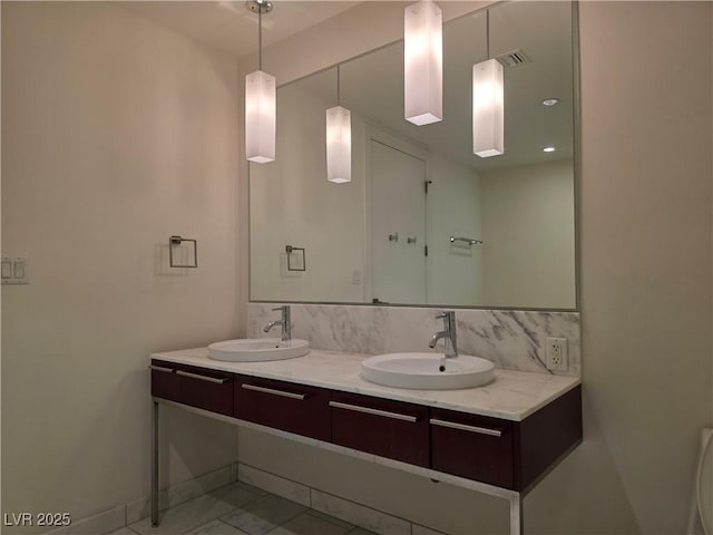 4471 Dean Martin Dr Unit 1104, Las Vegas, NV 89103 - bathroom with double vanity and baseboards