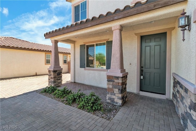 5425 Pride Mountain St, North Las Vegas, NV 89031 - entrance to property with stucco siding, covered porch, and a tile roof