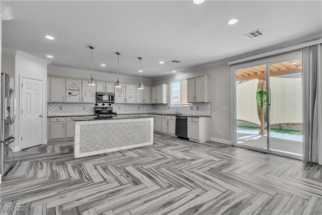 5425 Pride Mountain St, North Las Vegas, NV 89031 - kitchen with appliances with stainless steel finishes, tasteful backsplash, recessed lighting, a center island, and ornamental molding
