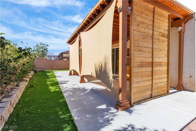 5425 Pride Mountain St, North Las Vegas, NV 89031 - view of side of home with stucco siding and a patio