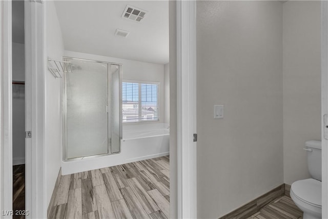 5425 Pride Mountain St, North Las Vegas, NV 89031 - bathroom with a shower stall, wood finished floors, and a garden tub